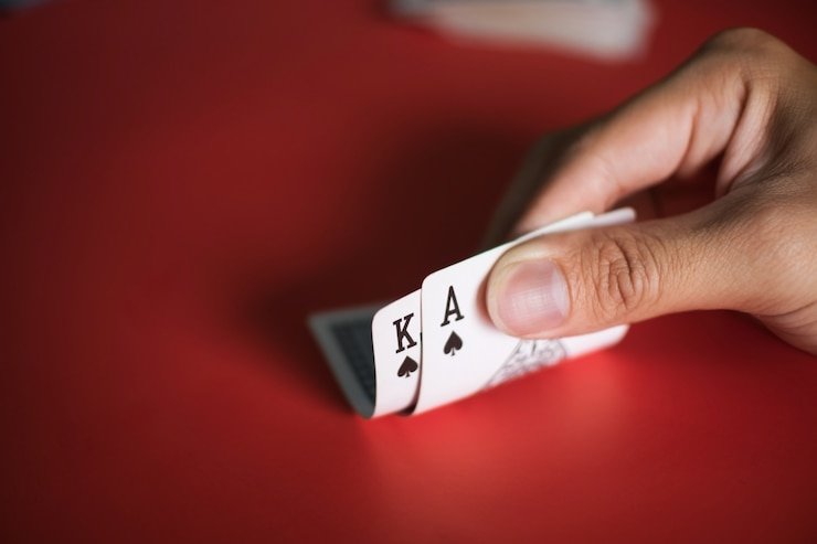 Capsa Susun card arrangement interface on adaqq showing front, middle, and back hand zones